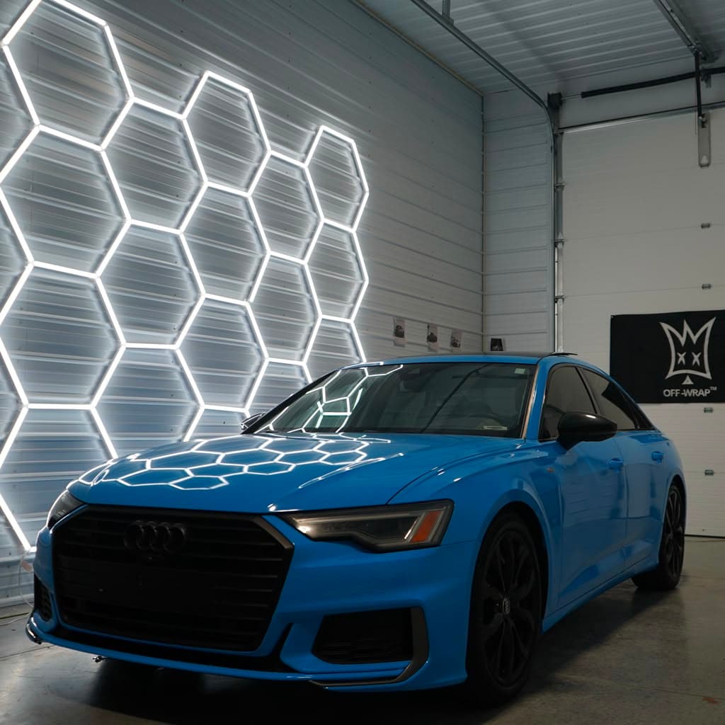 Finished Audi A6 in District 3 Performance blue wrap, front three-quarter studio reveal